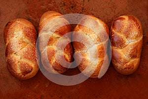 Four brioche pastries over orange clay photo