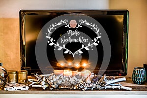 Four burning advent candles, beautiful decorated setup light TV in Background textspace saying merry christmas in German photo