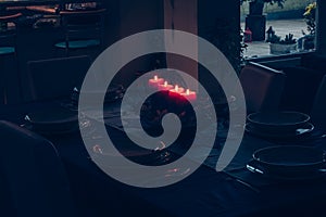 Four burning advent candles on the table prepared for christmas night