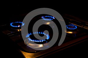 Four burning burners at night. Bright fire. The concept of expensive gas and energy resources. Increasingly expensive natural gas