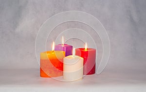 Four burning colored candles