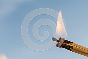 Four burning matches on a blue background