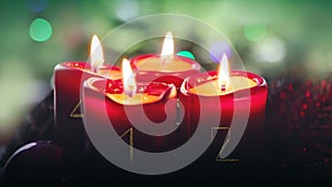 Four burning red candles for Advent. Christmas background.