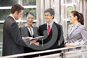 Four Business Colleagues Chatting Outside Office