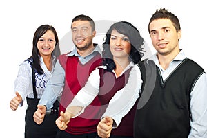 Four business people giving thumbs