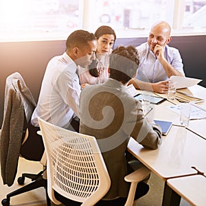 Four business professionals in a meeting indoors