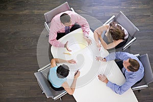 Four businesspeople at boardroom table