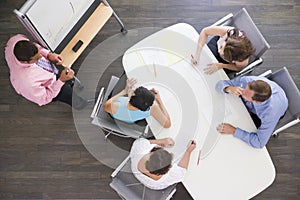 Four businesspeople at boardroom table