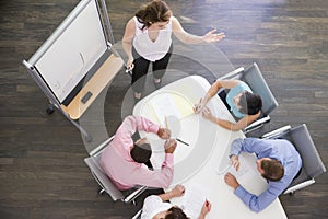 Four businesspeople at boardroom table