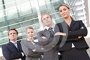 Four businesspeople standing outdoors smiling