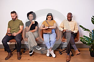 Four candidates sitting in a row waiting for job interview, creative tech coder