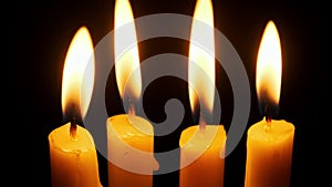 Four Candles Burning and Extinguished on a Black Background, Copy Space