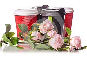 Four cardboard coffee cups flowers