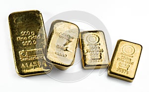 Four a cast gold bars of different weight on white