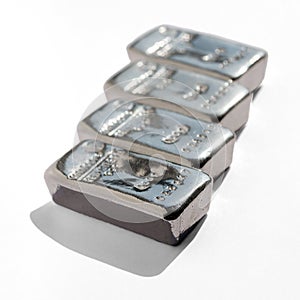 Four cast silver bars isolated on white background.