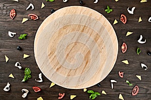 Four cheese pizza quattro fromaggi on a rustic wooden board on the table with ingridients.