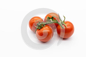 Four cherry tomatoes isolated on a white background