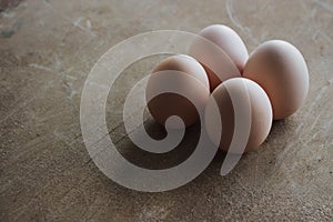 Four chicken organic eggs on rustic wooden background. Spring raw style