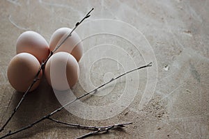 Four chicken organic eggs on wooden background. Spring raw fresh style