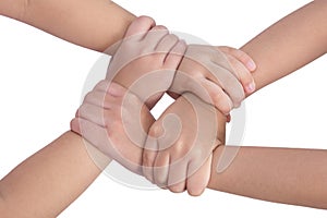 Four child`s hands crossed and holding each other