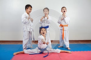 Four children demonstrate martial arts working together