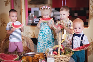 Four children eat fruit in the kitchen. Photo in retro style