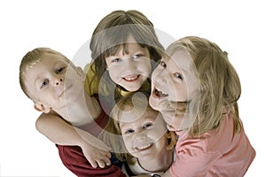 Four children hugging from above