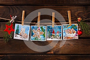 Four christmas cards hanging on rope against wooden background