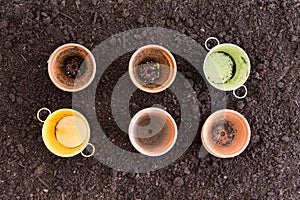 Four clay pots and two metal ones in rows of three