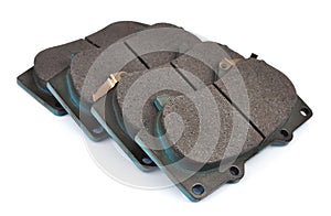 Four clean disc brake pads.