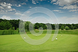 Four color balls on golf course, launching pad