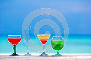 Four colorful exotic tasty cocktails background