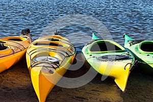 Four colorful kayaks locked with a chain
