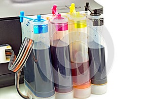 Four colour tanks on inkjet printer on white background