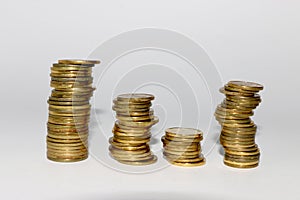 four columns of coins lined up on a white background