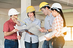 Four construction engineer working in side building plan for renovation, construction engineering conceptual