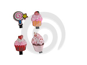 Four cupcakes and candy hair clips isolated on white background