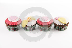 Four cupcakes isolated on white background