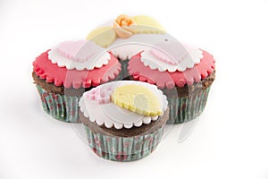 Four cupcakes on white background