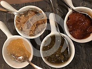 Four cups with different tipes of souses