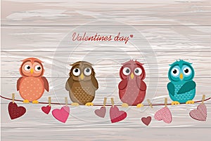 Four cute colored owlet sitting on a string. A red hearts with a