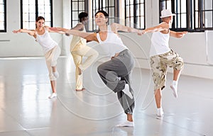 Four dancers exercising swing movements