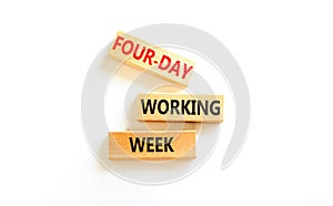 Four-day working week symbol. Concept words Four-day working week on wooden block on a beautiful white table white background.