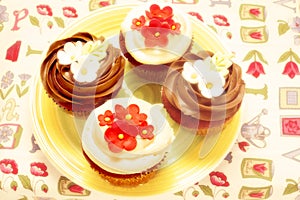 Four delicious cupcakes decorated