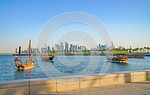 Four dhow moored in bay building in background