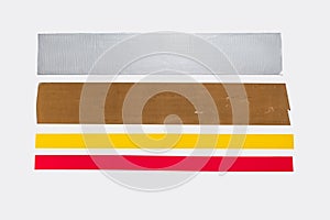 Four different adhesive tapes are glued to a white background