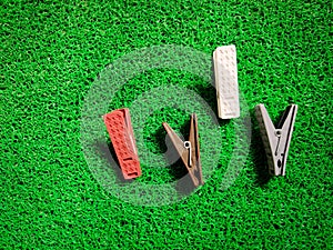 Four different colored plastic clothespins