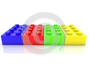 Four different colored toy bricks in a row