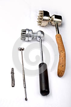 Four different old antique acupuncture hammers for chinese plum therapy on a white background.