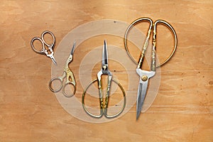 Four different types of scissors on a wooden background